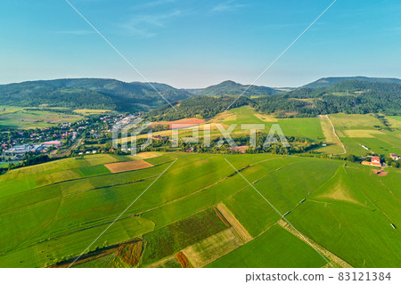 Mountain village and agricultural fields, aerial view. Nature landscape Mountain village and agricultural fields, aerial view. Nature landscape 83121384