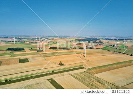 Windmill turbine in the field at summer day. Rotating wind generator 83121395