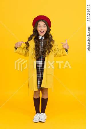 she is so surprised. little girl in coat going to school.  83121641