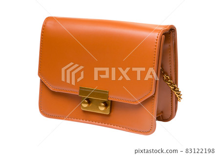 small orange leather ladies bag or clutch, with a chain strap, on a white background small orange leather ladies bag or clutch, with a chain strap, on a white background 83122198