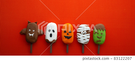 Set of ice cream with halloween character face on orange background. Halloween party background. Set of ice cream with halloween character face on orange background. Halloween party background. 83122207