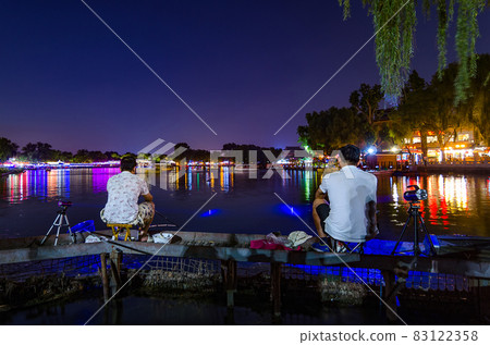 Two night fishermen fishing at the Shichahai lake in central Beijing, China Two night fishermen fishing at the Shichahai lake in central Beijing, China 83122358