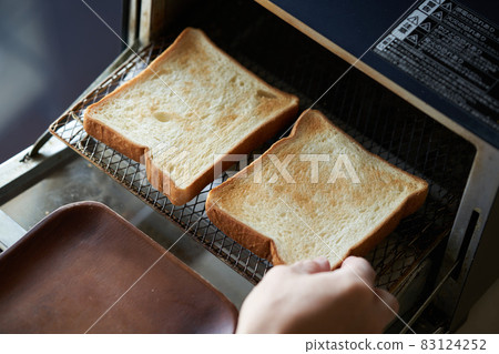 Bread baked in an oven toaster 83124252