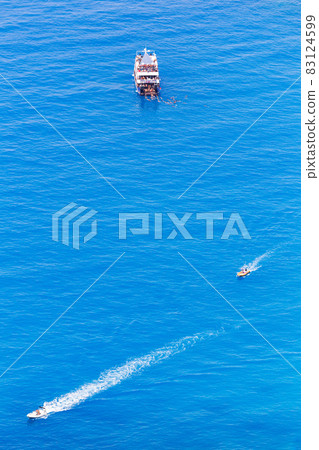 Aerial drone view of floating boats near the coast of Zakynthos, Greece Aerial drone view of floating boats near the coast of Zakynthos, Greece 83124599