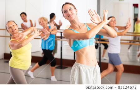 Group of women different ages training sport dance in studio Group of women different ages training sport dance in studio 83124672