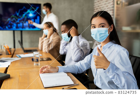 New Normal At Work. Business People Wearing Medical Masks At Corporate Meeting New Normal At Work. Business People Wearing Medical Masks At Corporate Meeting 83124735