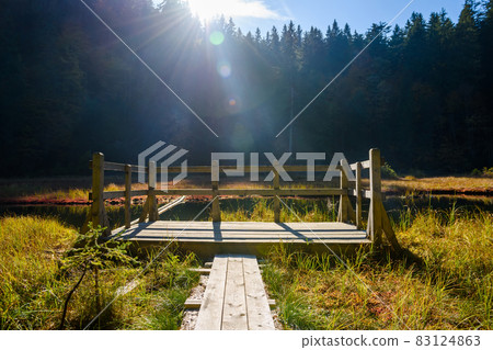 Wooden pier on a lake in the autumn mountains Wooden pier on a lake in the autumn mountains 83124863