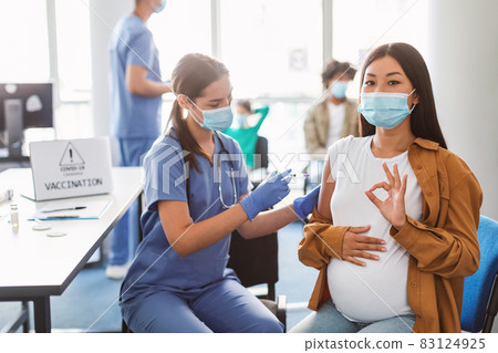 Pregnant Asian Lady Gesturing Ok Getting Vaccine Shot Pregnant Asian Lady Gesturing Ok Getting Vaccine Shot 83124925