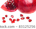 Ripe pomegranate fruit with slice and seeds isolated on a white background in close-up 83125256