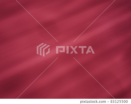 Diagonal rays of light on a pink or crimson background. Blurred abstract background light effect, light leaks. Side surface illumination. Parallel lines or stripes of light at an angle. 83125500