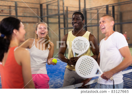 Two happy couples after playing padel on tennis court Two happy couples after playing padel on tennis court 83127665