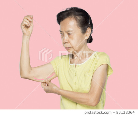 old asian woman pulls flabby skin 83128364