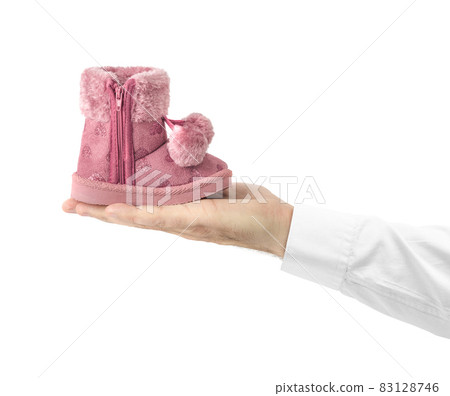 Hand with child shoe Hand with child shoe 83128746
