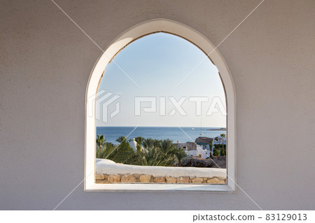 Egypt. A look through the frame on the palm trees. Beautiful view. White house and veranda overlooking the sea and palm trees. Egypt. A look through the frame on the palm trees. Beautiful view. White house and veranda overlooking the sea and palm trees. 83129013