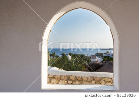 Egypt. A look through the frame on the palm trees. Beautiful view. White house and veranda overlooking the sea and palm trees. Egypt. A look through the frame on the palm trees. Beautiful view. White house and veranda overlooking the sea and palm trees. 83129020