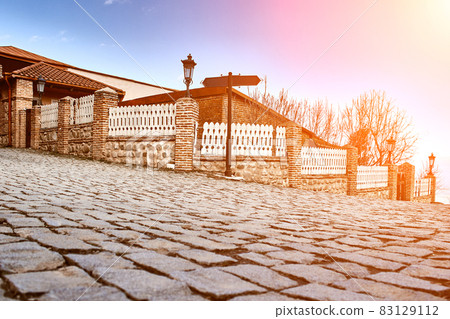 Picturesque street in Sighnaghi (Signagi), Kakheti , Georgia. Sighnaghi is known as a "Love City" in Georgia. Sun flare Picturesque street in Sighnaghi (Signagi), Kakheti , Georgia. Sighnaghi is known as a "Love City" in Georgia. Sun flare 83129112