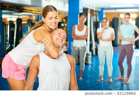 Young woman training chokehold Young woman training chokehold 83129968