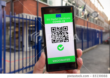 Woman showing on smartphone EU Digital Covid Certificate Green Pass. Woman showing on smartphone EU Digital Covid Certificate Green Pass. 83130088