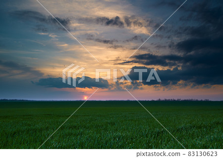 beautiful sunset sky, dark silhouette of clouds as a background 83130623