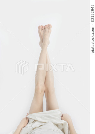 Back of female legs on white background Stock Photo