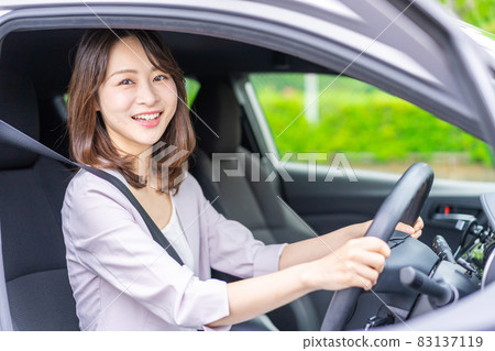 A young woman driving a car A young woman driving a car 83137119