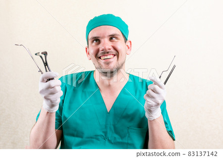 Funny doctor ENT, with instruments in his hands. Funny doctor ENT, with instruments in his hands. 83137142