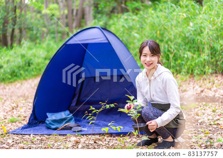 Young woman enjoying solo camp Young woman enjoying solo camp 83137757