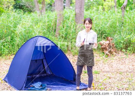 Young woman enjoying solo camp Young woman enjoying solo camp 83137763