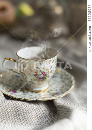 Porcelain tea pot and cup of hot tea on the table, antique traditional crockery set, high tea English afternoon tea 83138983