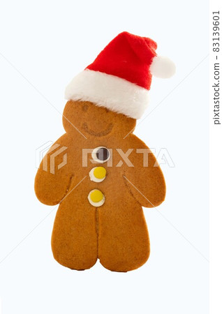 Gingerbread man cookie with Christmas red hat, isolated on white 83139601