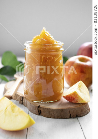 Apple jam in glass jar, delicious fruit jam, rustic style, day natural light. 83139726
