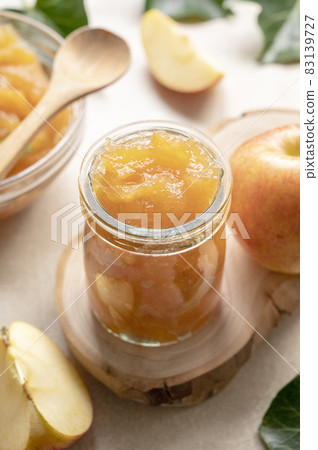 Apple jam in glass jar, delicious fruit jam, rustic style, day natural light. Apple jam in glass jar, delicious fruit jam, rustic style, day natural light. 83139727