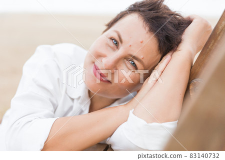 business woman smile and holds on to the neck business woman smile and holds on to the neck 83140732