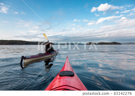 Adventurous Woman on Sea Kayak paddling in the Pacific Ocean. 83142276