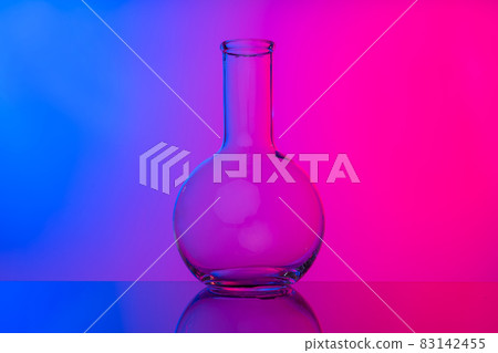 Chemical glassware close up on neon pink-purple background 83142455