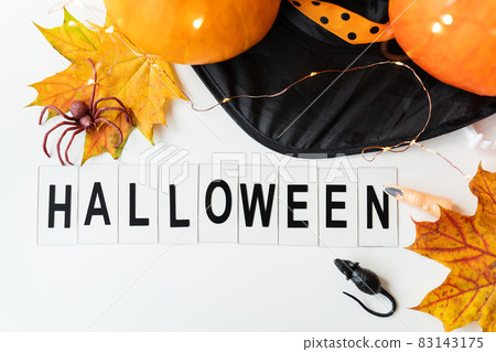 Halloween inscription isolated on white background. Against the background of a spider, a mouse, a hat, yellow leaves. Holiday and party concept. Halloween inscription isolated on white background. Against the background of a spider, a mouse, a hat, yellow leaves. Holiday and party concept. 83143175