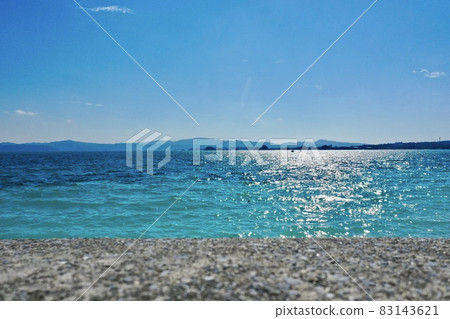 Aerial view of the blue sea of the main island of Okinawa with a drone (Kouri Island) 83143621