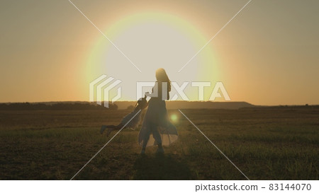mom circles her little daughter at sunset in the field, a cheerful kid flies in the air in the sun, play superhero, happy family, mother's love for a child, a walk with baby in nature mom circles her little daughter at sunset in the field, a cheerful kid flies in the air in the sun, play superhero, happy family, mother's love for a child, a walk with baby in nature 83144070