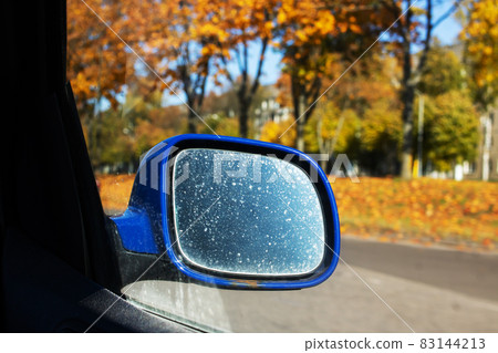 Car side mirror on the background of the autumn road Car side mirror on the background of the autumn road 83144213
