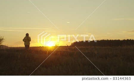 girl runs at sunset, silhouette of woman preparing for running competition, doing sports in nature outdoors, keeping an eye on her figure and health, living in body movement, morning jogging at dawn girl runs at sunset, silhouette of woman preparing for running competition, doing sports in nature outdoors, keeping an eye on her figure and health, living in body movement, morning jogging at dawn 83144363