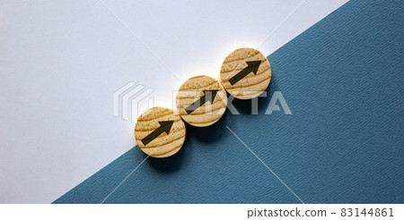 Business concept growth success process. Wood circles stacking as step stair on paper white and blue background, copy space. Business concept growth success process. Wood circles stacking as step stair on paper white and blue background, copy space. 83144861