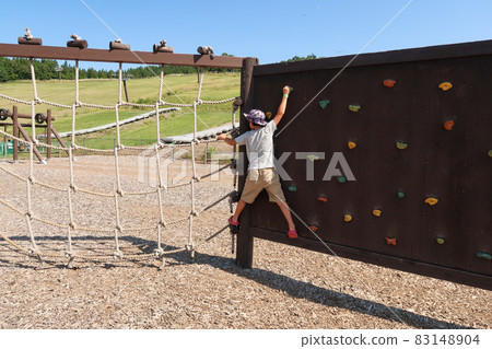 Kids playing with outdoor climbing playset 83148904