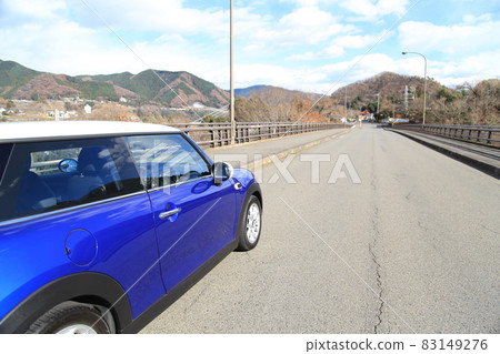 Drive with blue MINI on a sunny day 83149276