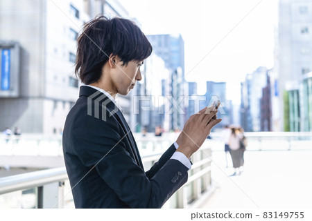 Businessman operating a smartphone Shibuya Businessman operating a smartphone Shibuya 83149755