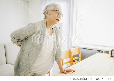 Elderly woman with a backache Elderly woman with a backache 83150448