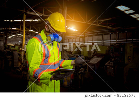 Engineer industry wearing safety uniform ,black gloves ,gas mask feel suffocate when under checking chemical tank in industry factory work. Engineer industry wearing safety uniform ,black gloves ,gas mask feel suffocate when under checking chemical tank in industry factory work. 83152575