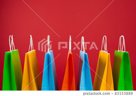 Arrangement of shopping bags on red background 83153889