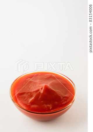 Tomato ketchup in glass bowl on white background. Sauce in bowl and copy space. Tomato ketchup in glass bowl on white background. Sauce in bowl and copy space. 83154006