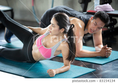 FITNESS AND WORKING OUT concept. Active lifestyle of Young people exercise and workout at fitness gym. FITNESS AND WORKING OUT concept. Active lifestyle of Young people exercise and workout at fitness gym. 83154134