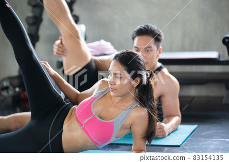 FITNESS AND WORKING OUT concept. Active lifestyle of Young people exercise and workout at fitness gym. FITNESS AND WORKING OUT concept. Active lifestyle of Young people exercise and workout at fitness gym. 83154135